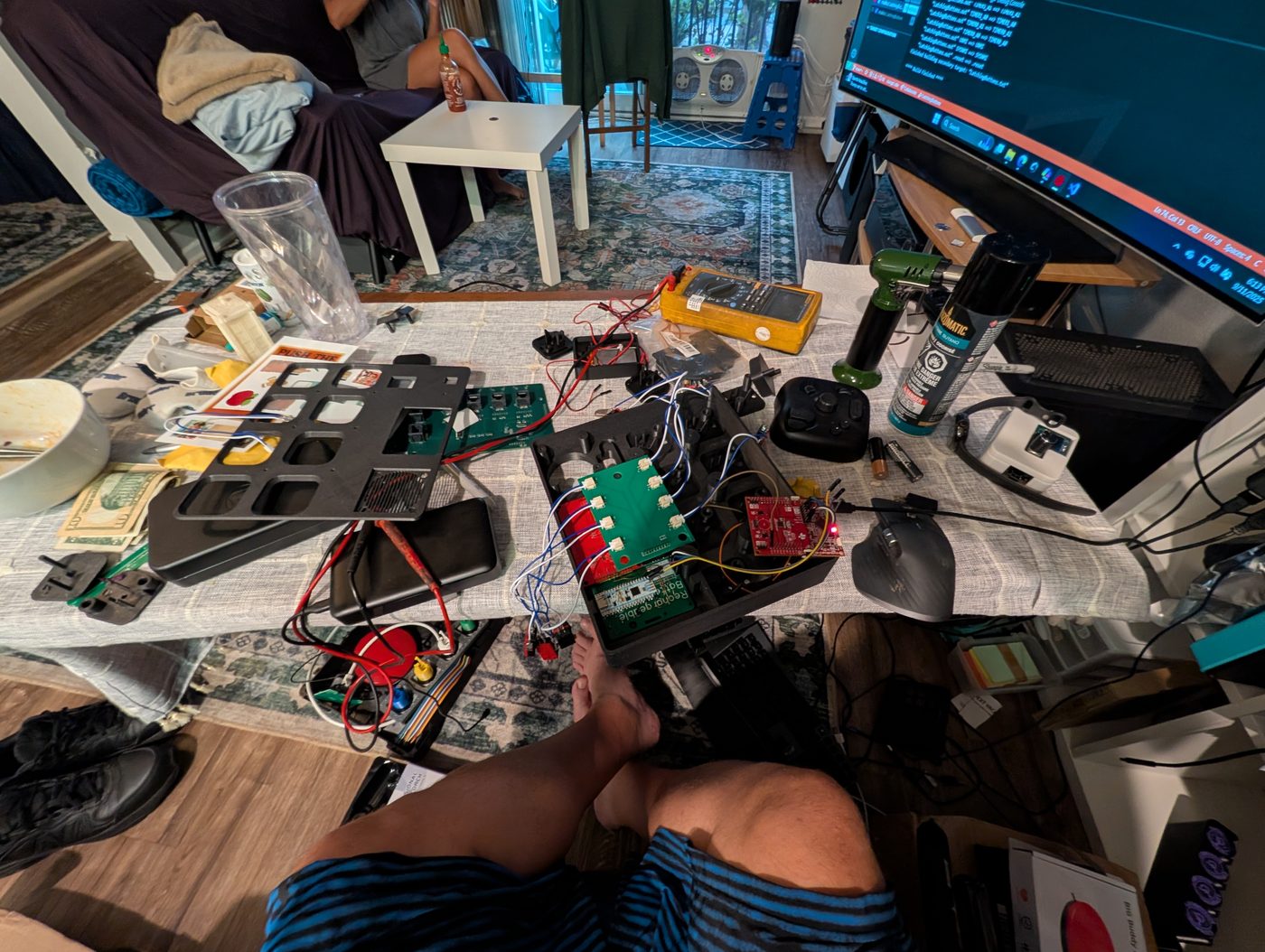 Workbench covered in electronics and prototypes