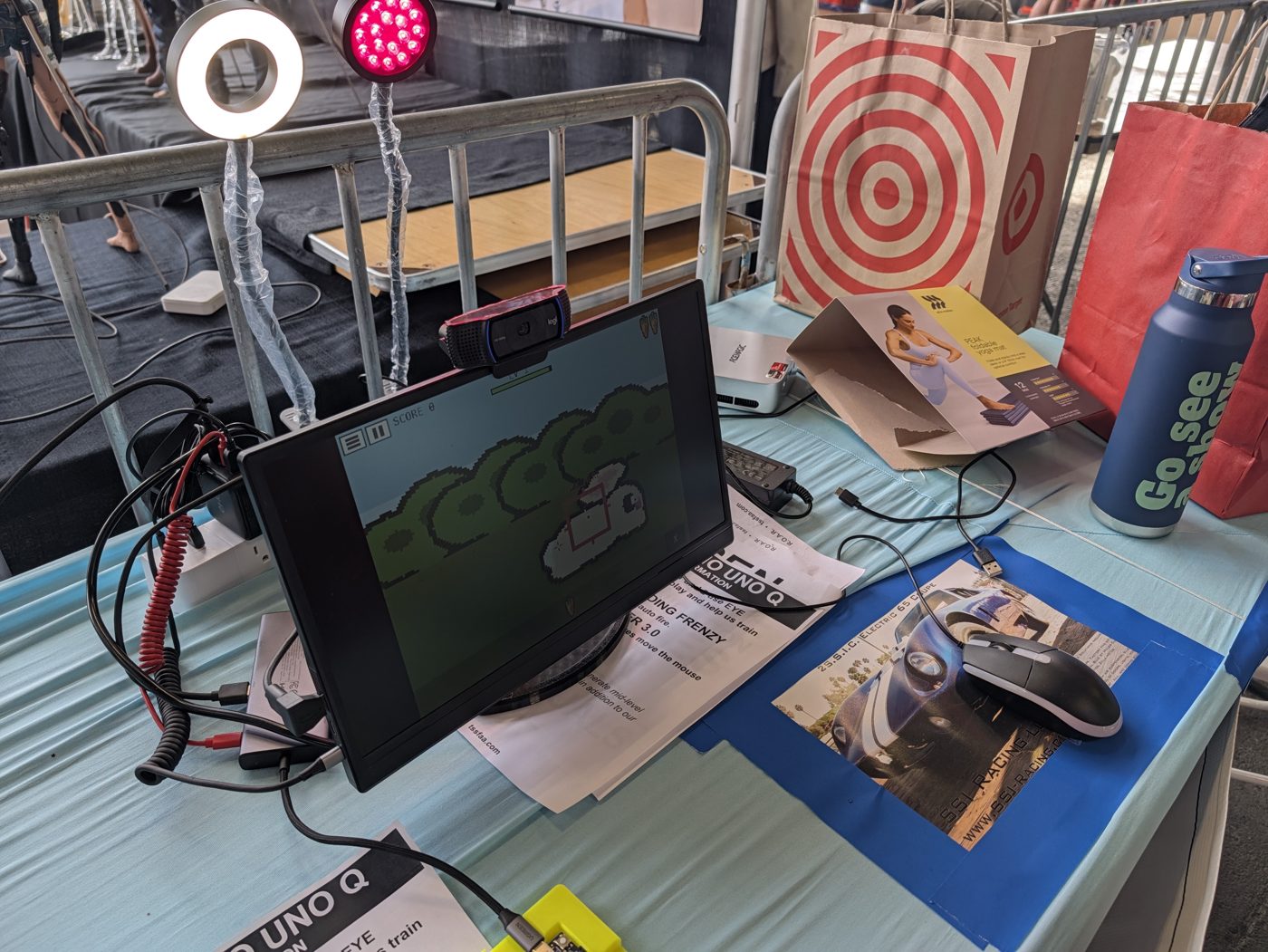 The eye-tracking station at Maker Faire: a ring light and a red LED lamp mounted above the screen, webcam on top