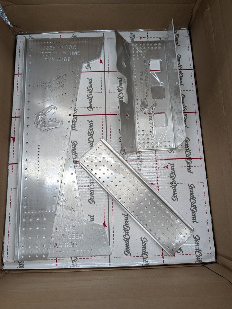 SendCutSend box opened — raw laser-cut parts